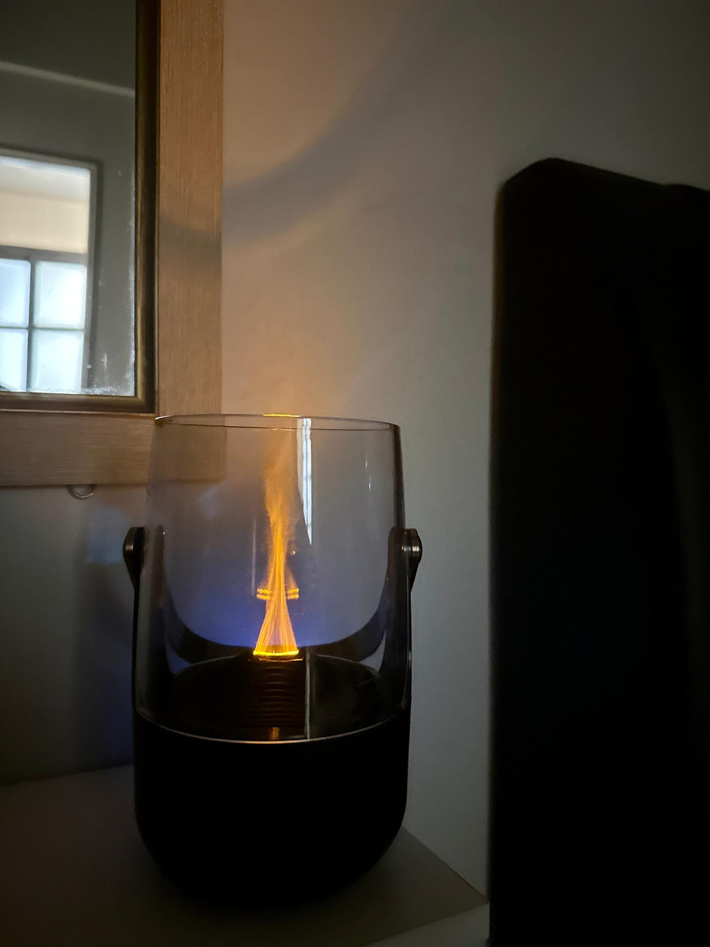 LumoFlare aroma diffuser warm orange flame reflection at night | Fixxora