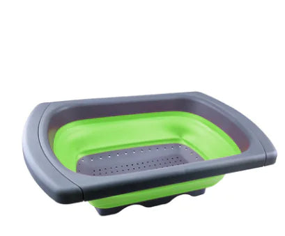 Green collapsible colander with gray rim shown fully expanded on white background