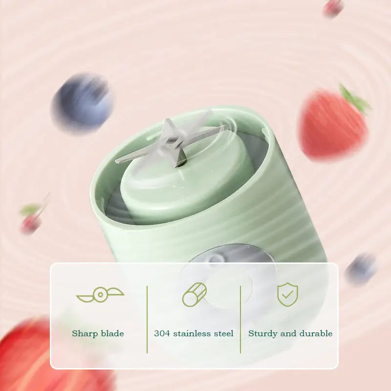 Pastel portable blender close-up showing lid and power button with fruit decoration background