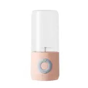 Compact pink portable blender with detachable cup and pastel design on white background